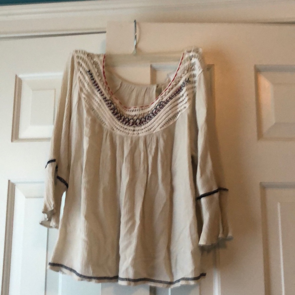 Creme top, red, and navy detail, open back
